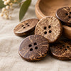 Loose coconut shell buttons in varied shades of brown laid on a printed aloha shirt fabric